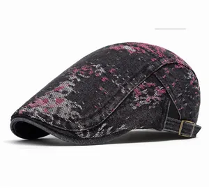 Dettaglio del berretto vintage in denim con fibbia in bronzo e stampa astratta rosa