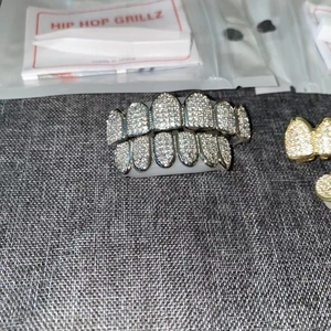 Macro detail of gold and silver plated hip hop grillz with micro-pave cubic zirconia