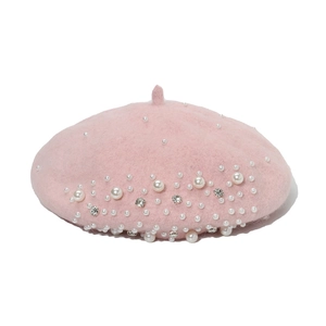 Close-up of pink wool beret featuring elegant pearl and rhinestone embellishments
