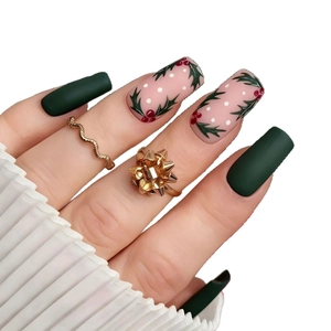 Christmas press-on nails with matte green finish and holly berry leaf patterns