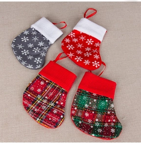 Set of four mini Christmas stocking ornaments with snowflake and plaid holiday patterns