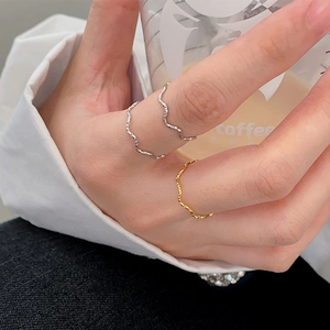 Minimalist wavy titanium steel rings in gold and silver finish for layered styling