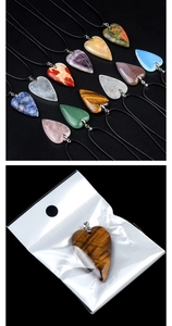 Macro shot of natural crystal heart pendants in individual packaging for DIY jewelry