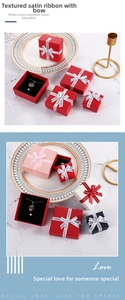 Close-up of elegant jewelry gift boxes with ribbon bows and soft black velvet lining