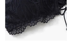 Close-up of intricate black lace texture and floral patterns on strapless tube top bra