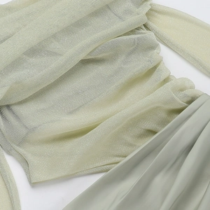 Detail of glittery Lurex mesh bodice joined with smooth sage green satin dress fabric