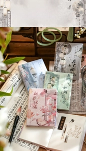 Close-up of A7 notebooks with traditional Chinese ink paintings and elegant calligraphy