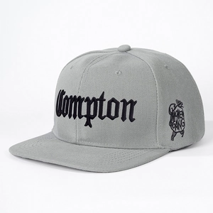 Grey snapback flat brim hat with black gothic Compton embroidery and side graphic logo