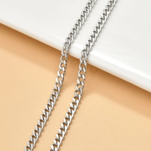 Y2K silver Cuban link chain necklace with high polish finish on a neutral background