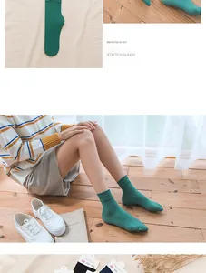 Detail of green combed cotton crew socks with ribbed texture and slouchy cuff design