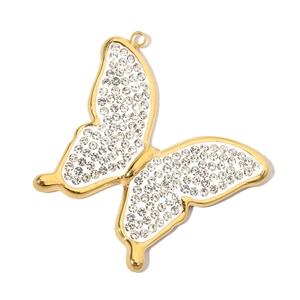 Detailed view of a golden butterfly pendant with sparkling clear rhinestones on white