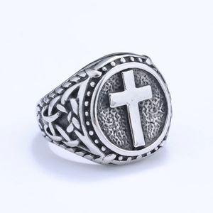 Vintage stainless steel ring featuring a raised cross design with Celtic knot engravings