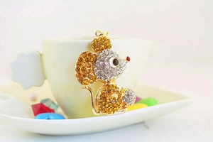 Close-up of golden mouse keychain featuring yellow and clear crystal rhinestones