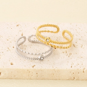 Macro detail of French vintage double beaded rings with zircon in gold and silver