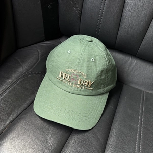 Close-up of light green baseball cap featuring premium letter and bear embroidery detail