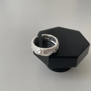 Detailed macro of S925 sterling silver ring featuring a moon crater hammered texture