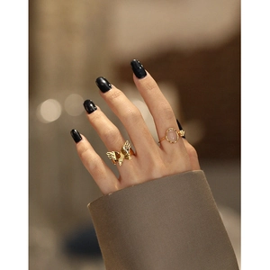 Irregular silver floral bud ring set with pink agate gemstone and butterfly wing design
