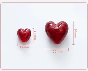 Detail view of red heart glitter glass beads in 12mm and 20mm sizes for DIY jewelry