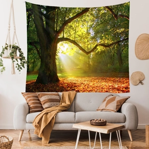 Detail of forest tapestry with autumn leaves and sunlight hanging above a sofa