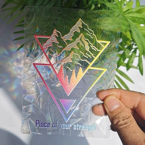Detail of geometric suncatcher sticker with rainbow prism effect and motivational text
