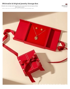 Detail of red jewelry box with geometric texture, velvet lining and best wishes ribbon