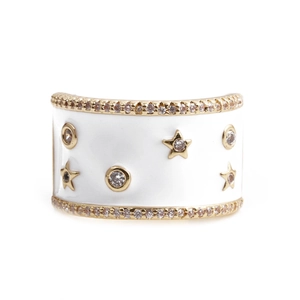 Detailed view of the wide white enamel star and moon ring with gold accents and zircons
