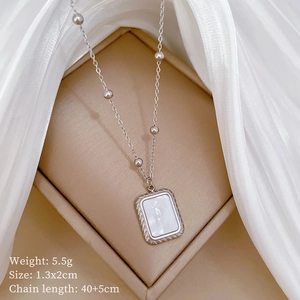 Macro view of square shell pendant necklace with silver chain and product dimensions