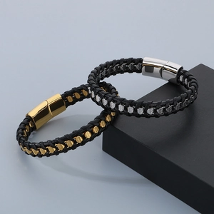 Close-up of men's braided leather bracelets with metallic magnetic clasps on a display