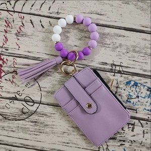Detail of purple faux leather wallet with silicone bead wristlet and gold zipper