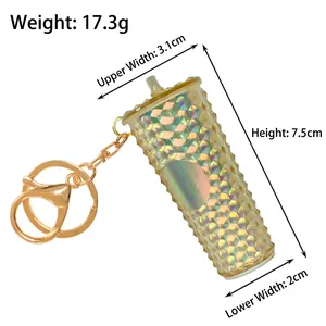 Detailed view of iridescent golden cup keychain with 17.3g weight and size specifications