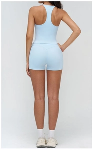Rear view of light blue racerback yoga tank top and matching athletic shorts