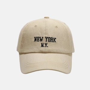 Detail of New York embroidery on beige cotton twill baseball cap with curved brim