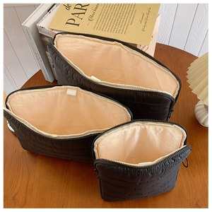 Three-piece black quilted organizer bag set with nylon texture and gold zip closure