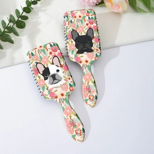 Close-up of floral French Bulldog pattern design on the back of cushioned hairbrushes