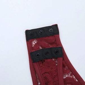Detail of burgundy lace bodysuit featuring a black three-row snap button closure at the crotch