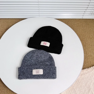Kids double-layer wool knit beanies in black and dark grey with BAKE cloth label