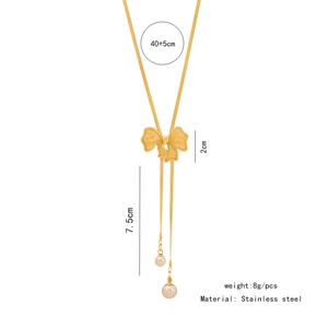 Detail view of gold stainless steel snake chain with bow pendant and pearl tassels