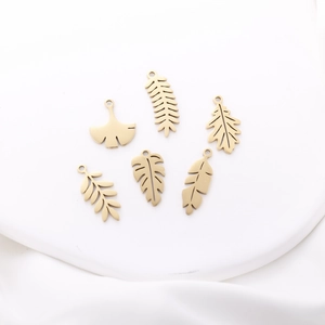 Golden stainless steel leaf charms collection with monstera and ginkgo designs