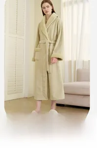 Detail of light green coral fleece robe featuring beige lamb wool trim on sleeves and pockets