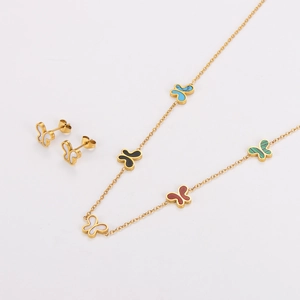 Close-up of golden stainless steel jewelry set featuring colorful butterfly pendants