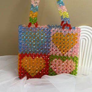 Detailed close-up of colorful handmade beaded tote bag with vibrant acrylic bead patterns
