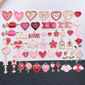 Detailed close-up of mixed red and pink heart charms for DIY jewelry making