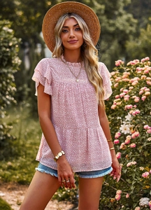 Detail view of pink floral top with ruffle butterfly sleeves and layered hemline