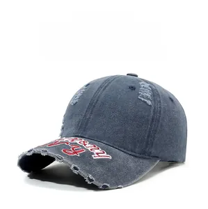 Détails d'une casquette en denim vintage avec broderies et finitions déchirées