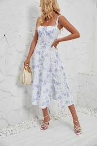 Detail of blue floral sun dress featuring a tied bust and high side slit for summer