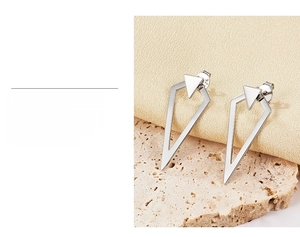 Macro detail of geometric S925 silver stud earrings showing high-quality plating and certification