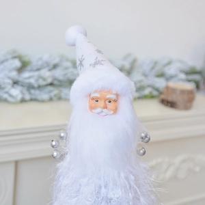 Close-up of white Santa ornament with silver snowflake sequins and metallic bells