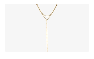 Detail of a gold double-layer Y-shaped tassel body chain with fine polished texture