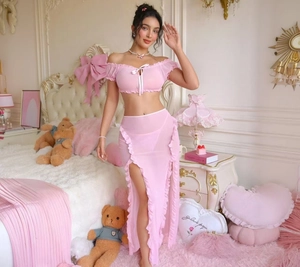 Detail of pink mesh babydoll with bubble sleeves, ribbon bow and ruffled high-slit skirt