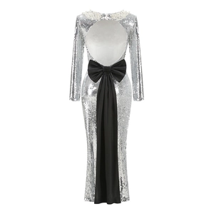Detail of silver sequin evening gown featuring open back and large black satin bow